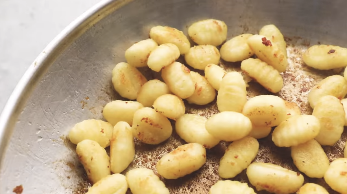 Gnocchi is being seared in a skillet