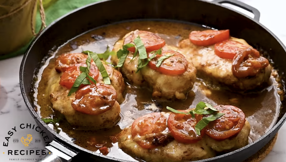 Baked margherita chicken is in a skillet. 