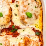 up close image of chicken parmesan casserole in baking dish