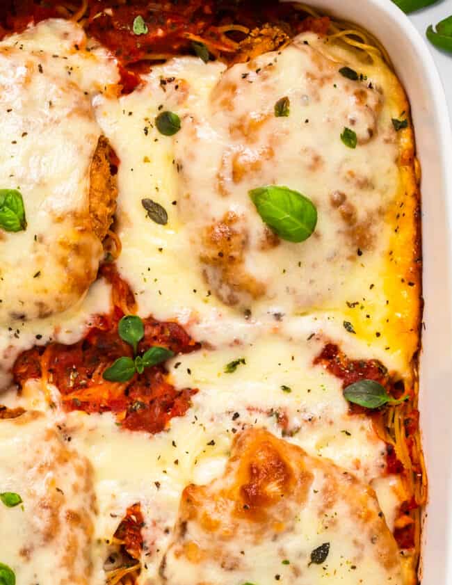 up close image of chicken parmesan casserole in baking dish
