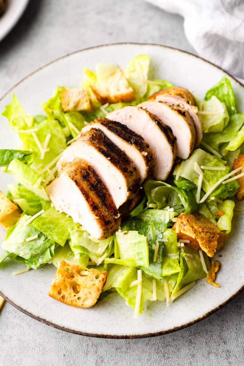 sliced grilled chicken on salad