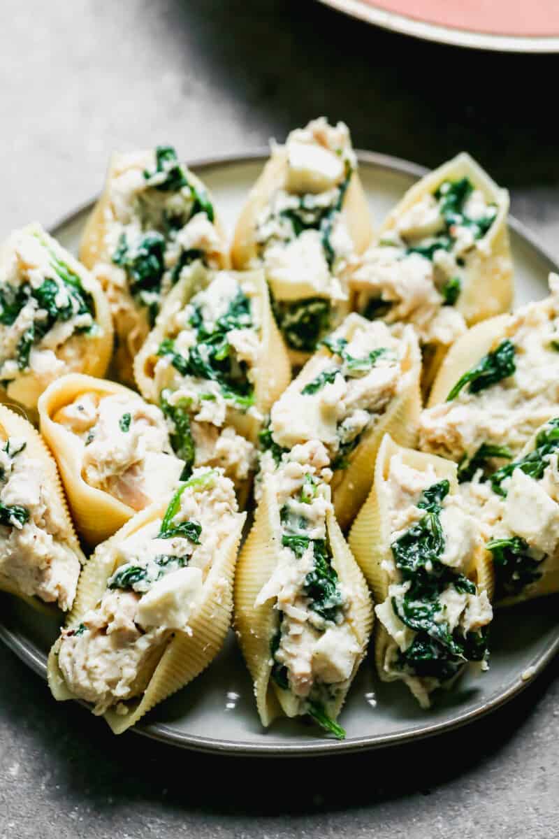 prepping stuffed shells with chicken and spinach