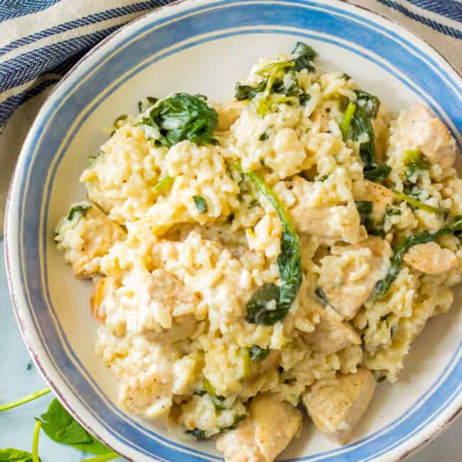 garlic chicken and rice with spinach on white plate