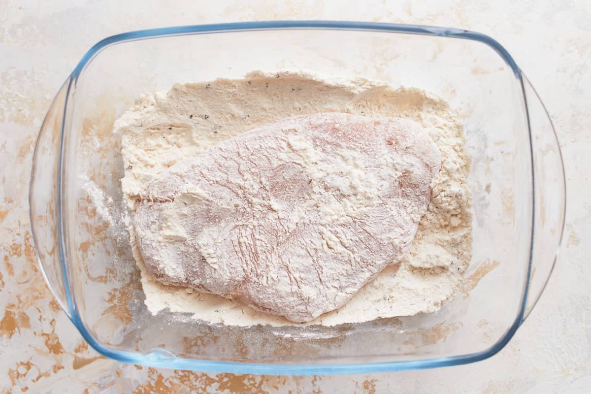 a chicken breast dredged in flour.