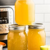 3 mason jars filled with instant pot chicken stock