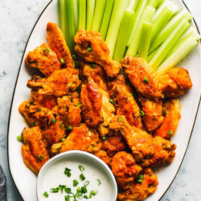 instant pot buffalo wings on platter with celery and blue cheese