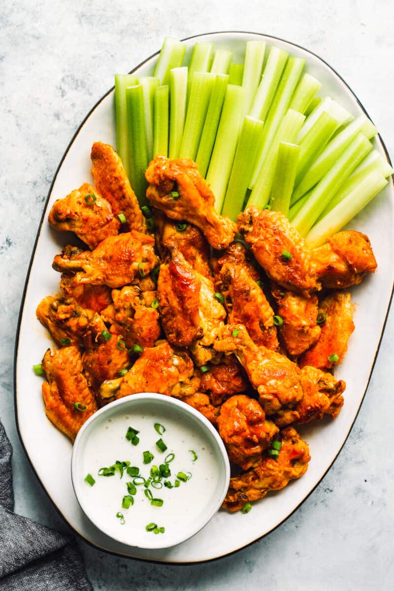 instant pot buffalo wings on platter with celery and blue cheese