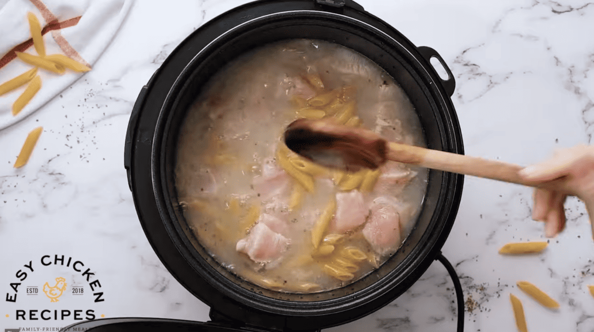Broth, chicken and pasta are placed in an Instant Pot. 
