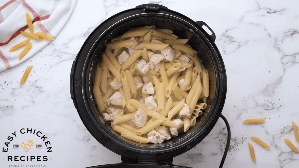Cooked noodles and chicken are in the Instant Pot.