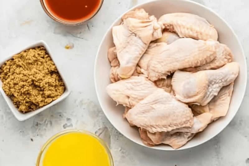portioned ingredients for air fryer chicken wings in individual containers.