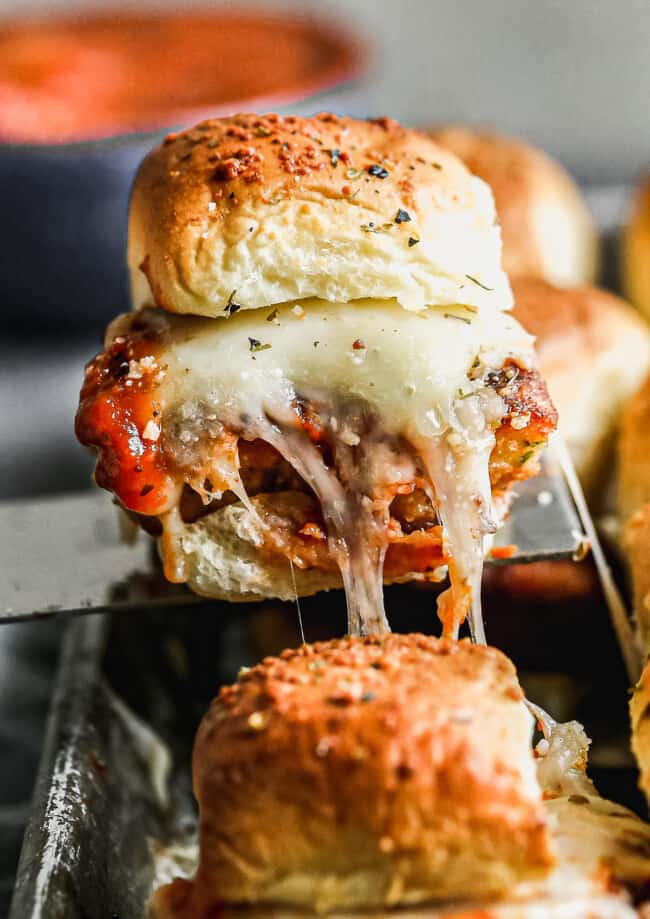 up close image of chicken parm slider with cheese pull