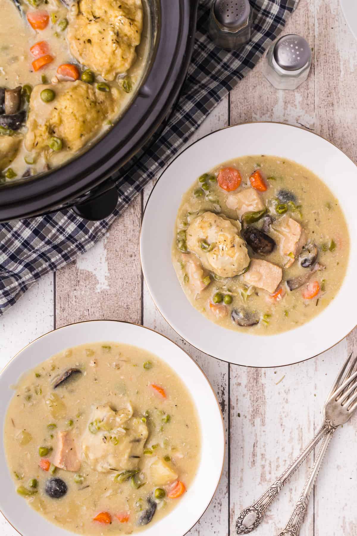 two bowls of crockpot chicken and dumplings