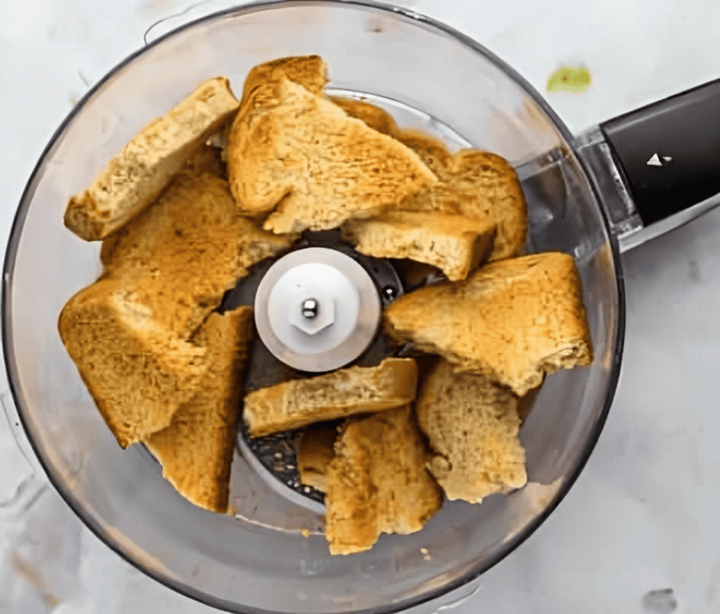 pieces of toast in a food processor.