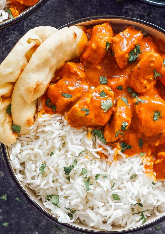 up close image of bowl of chicken tikka masala with rice