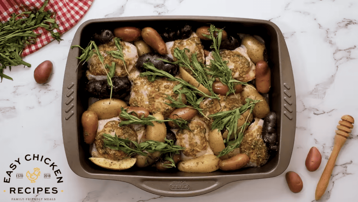 tarragon is placed on top of chicken and potatoes in a baking dish