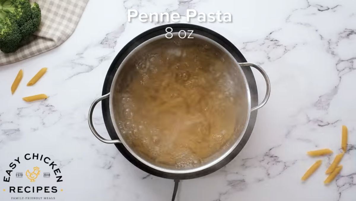 Pasta is boiling in a pot of water.