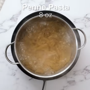 Pasta is boiling in a pot of water.