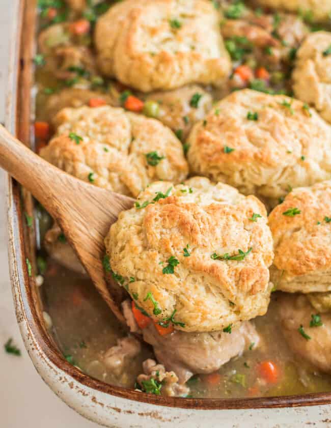 lifting up chicken biscuit bake with wooden spoon