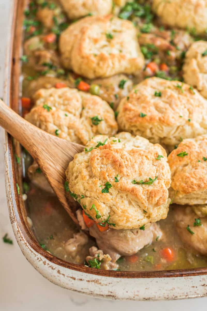 lifting up chicken biscuit bake with wooden spoon