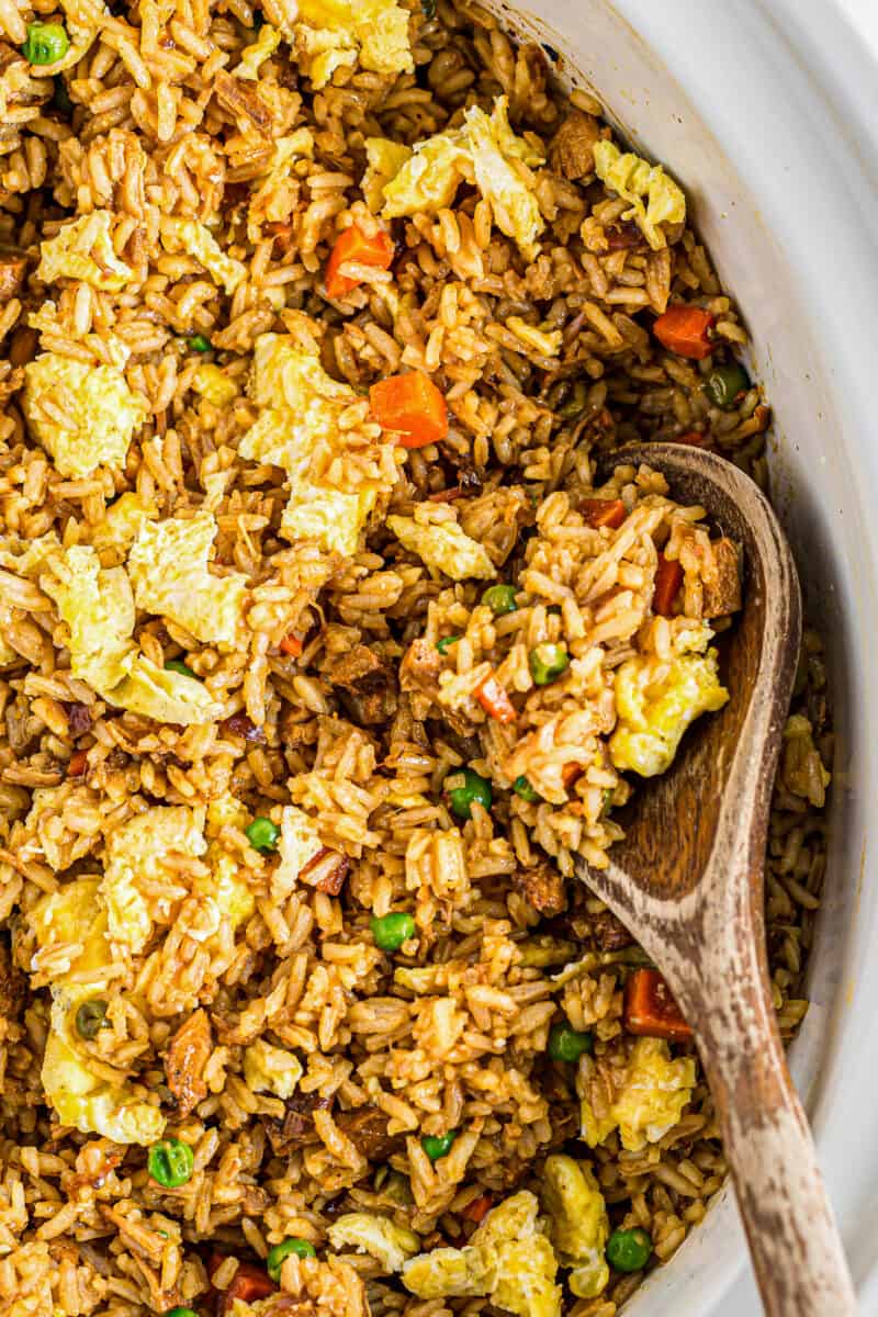 wooden spoon with crockpot chicken fried rice
