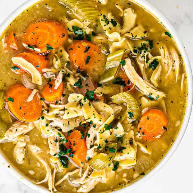 white bowl of crockpot chicken noodle soup