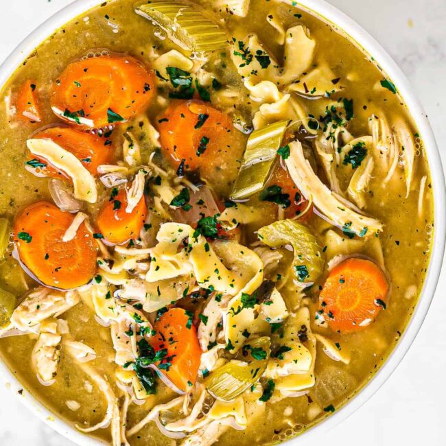 white bowl of crockpot chicken noodle soup