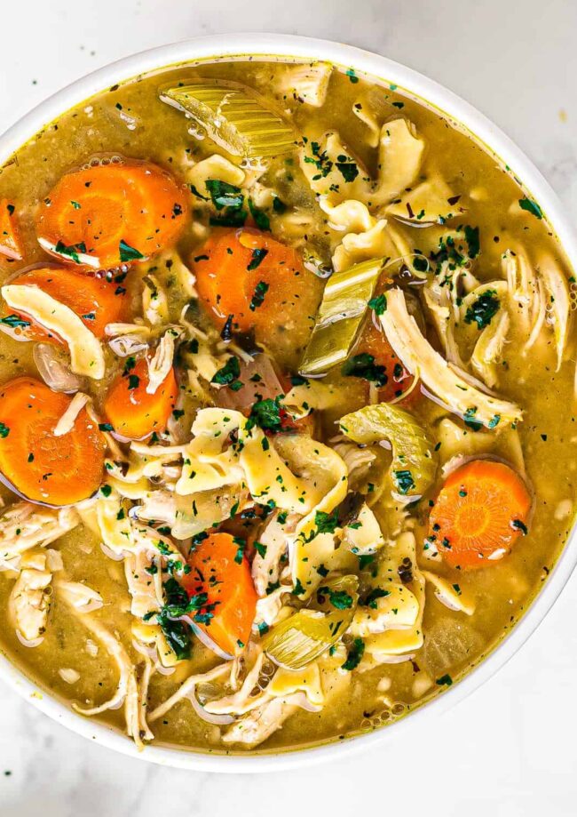 white bowl of crockpot chicken noodle soup