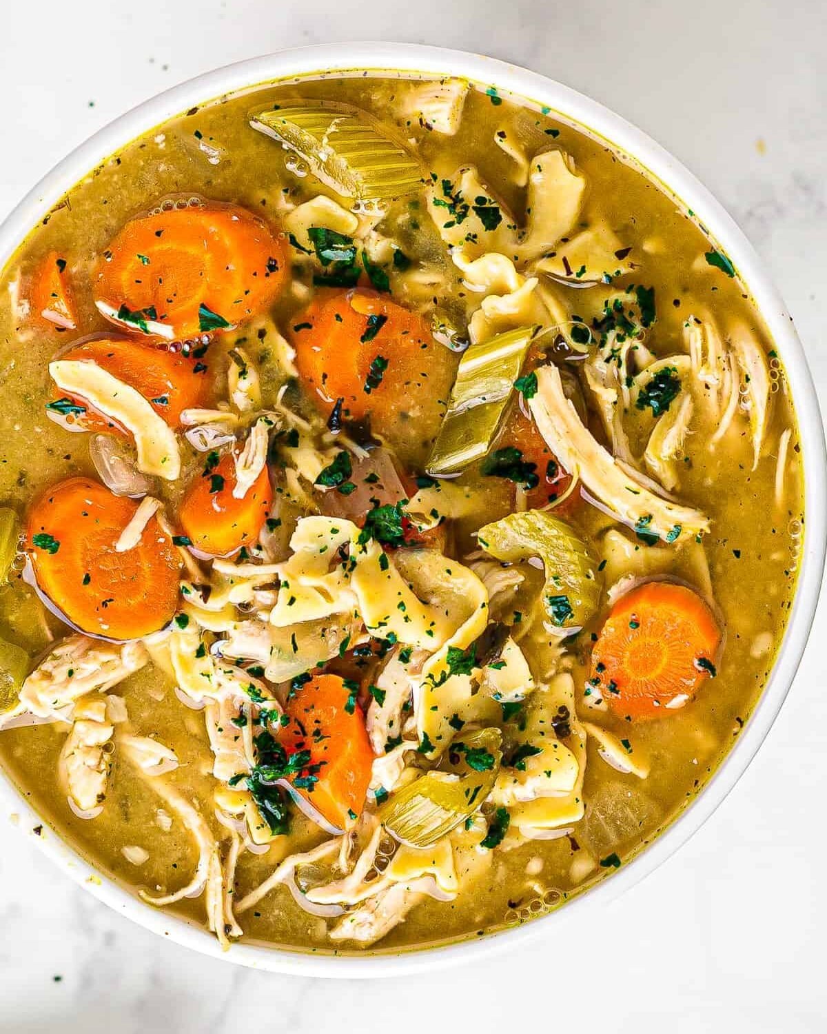 white bowl of crockpot chicken noodle soup