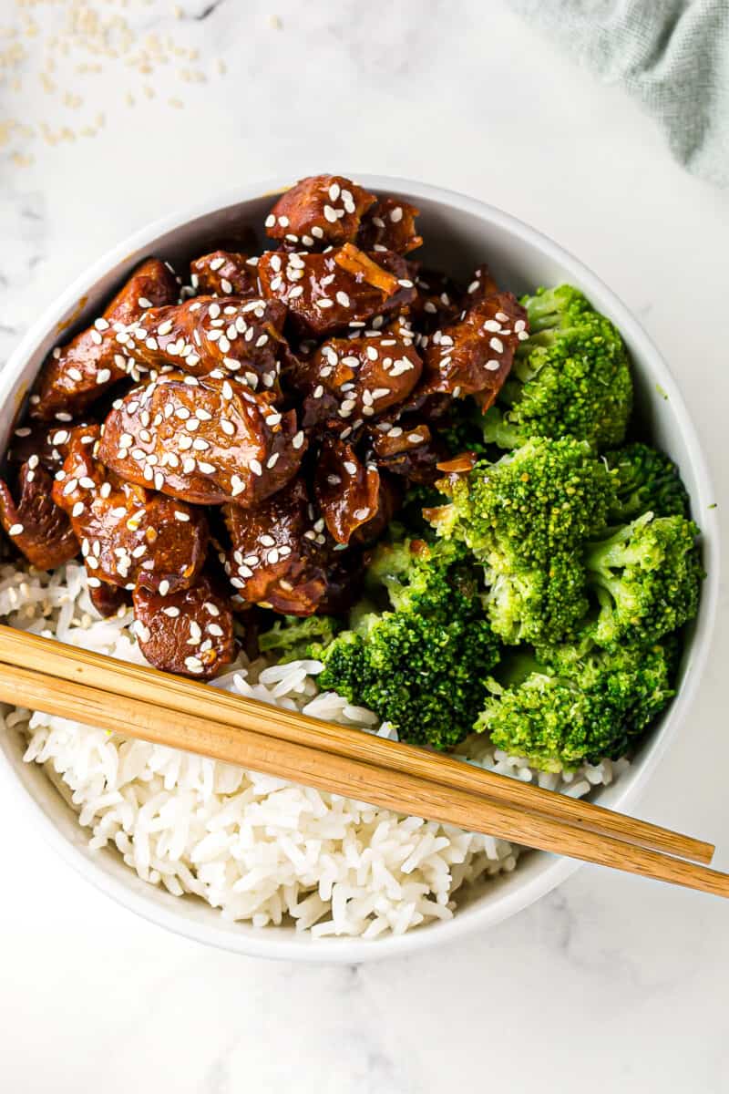 crockpot sesame chicken with broccoli and rice in white bowl