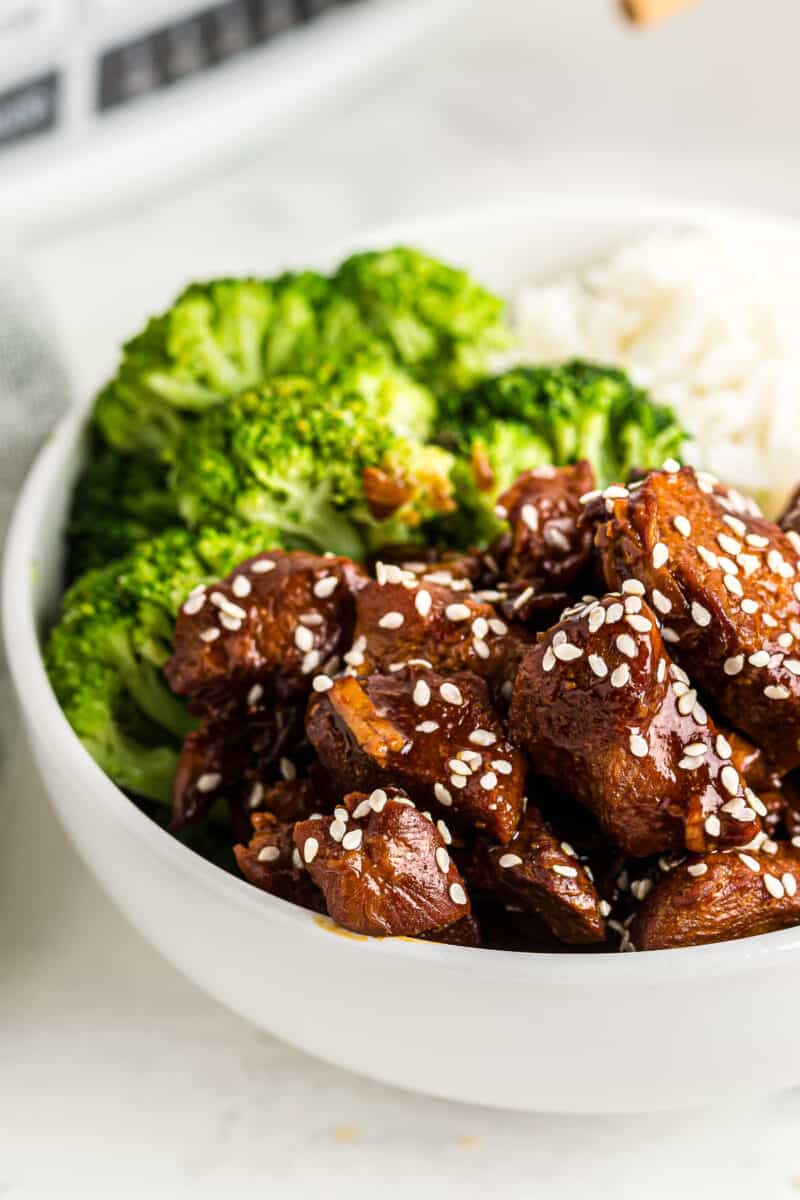crockpot sesame chicken with broccoli and rice in white bowl
