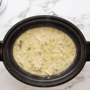 white chicken enchilada soup in a crockpot.