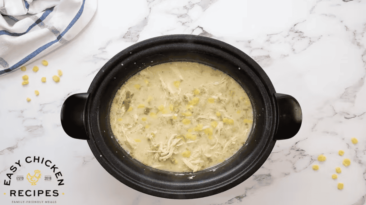 white chicken enchilada soup in a crockpot.