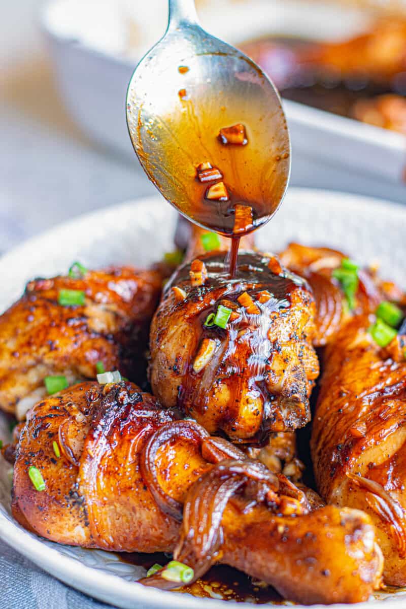 pouring honey soy sauce on chicken drumsticks