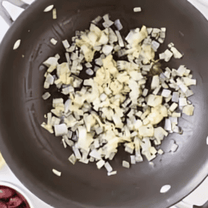 sauteeing onions in a frying pan.