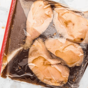 chicken breasts in bourbon marinade in a Ziplock bag.