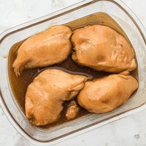 bourbon marinated chicken breasts in a glass baking dish.