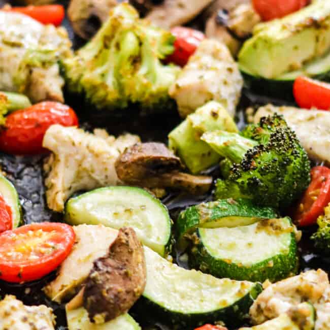 sheet pan pesto chicken with broccoli, mushrooms, and tomatoes