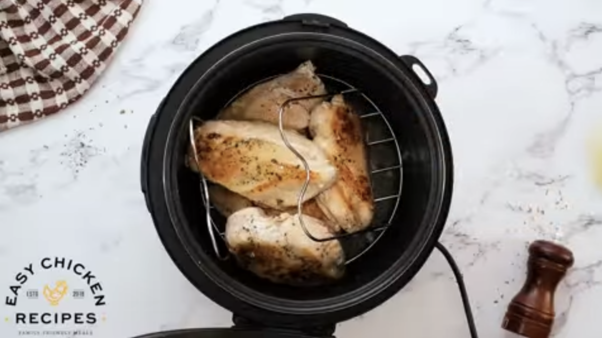 Chicken breasts are on a trivet in the instant pot. 