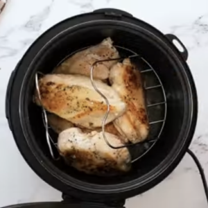 Chicken breasts are on a trivet in the instant pot.