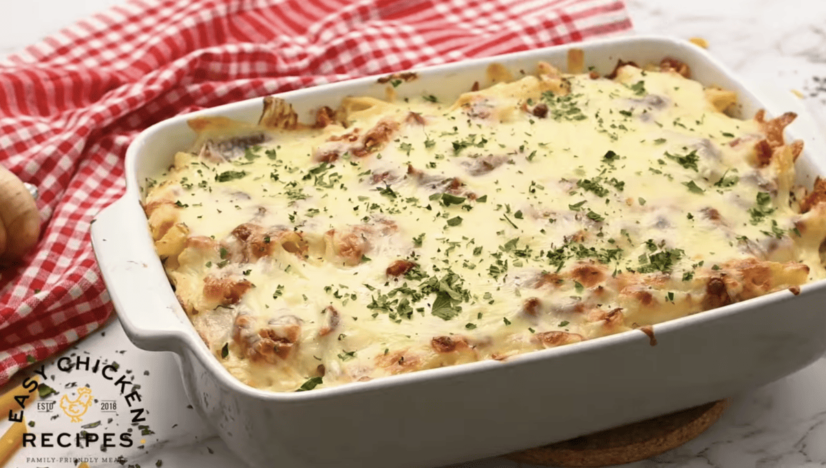 A chicken and bacon casserole dish with ranch sauce and pasta, topped with melted cheese.