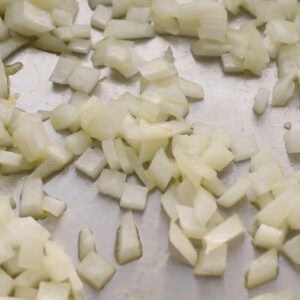 sautéed diced onion in a pan.