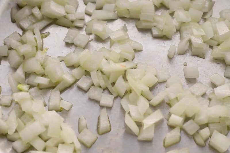 sautéed diced onion in a pan.