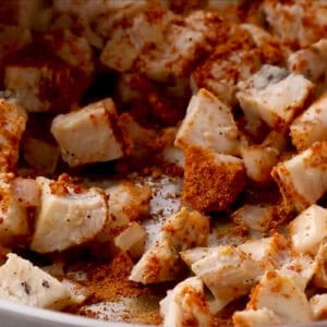 sautéed chicken and onion seasoned with taco seasoning in a pan.