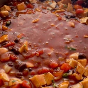 enchilada chicken mixture with cilantro in a pan.