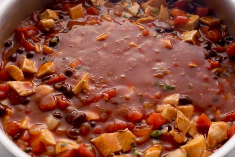 enchilada chicken mixture with cilantro in a pan.
