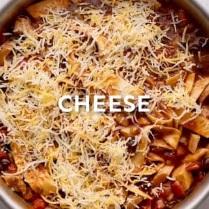 sprinkled cheese over chicken enchilada skillet with text "CHEESE" overlayed.