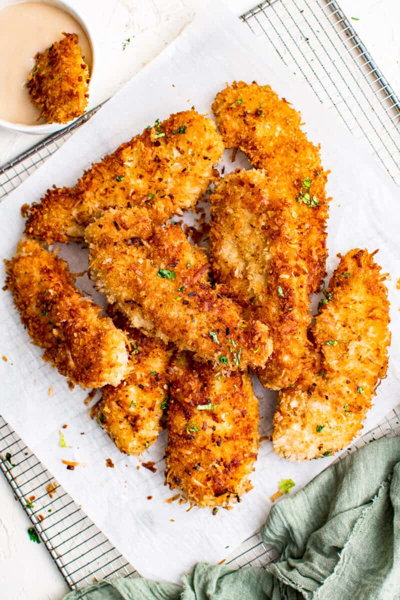 crispy baked coconut chicken tenders on parchment