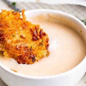 dipping coconut chicken tender in pina colada dip