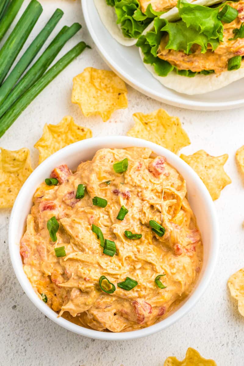 white bowl of crockpot queso chicken with chips