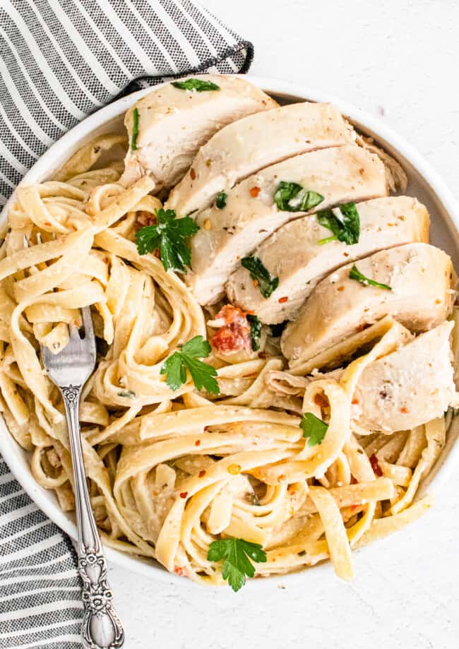white plate with crockpot tuscan chicken